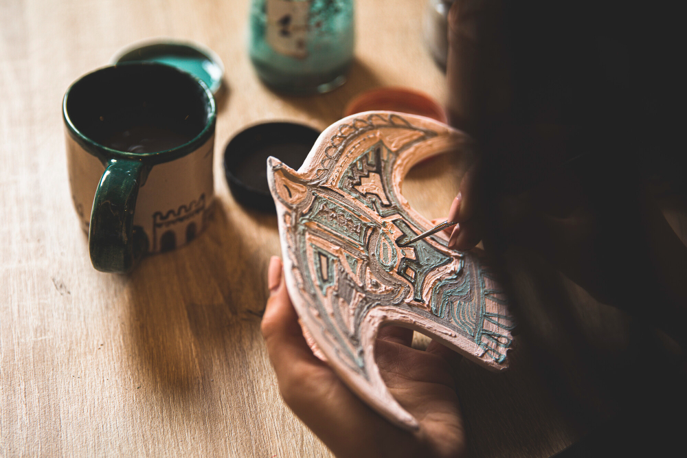 Handicracts business - Woman making Pottery embedded pigeon figure